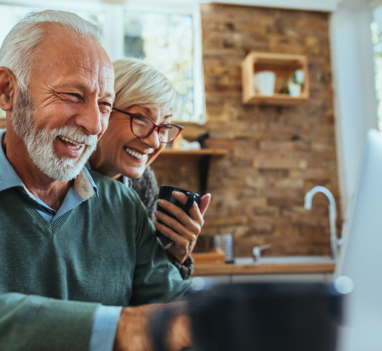 Couple smiling and using computer